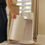 Mother removes dirty diaper compartment easily from the diapersealer pail.