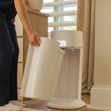 Mother removes dirty diaper compartment easily from the diapersealer pail.